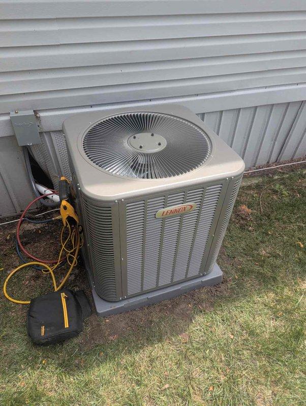Completed full HVAC system installation including a 60,000 BTU gas furnace and 2.5-ton air conditioning condenser unit. The outdoor condenser was positioned on a concrete pad in the yard with proper clearances from the building structure. All refrigerant lines were connected, evacuated, and charged to manufacturer specifications using manifold gauges. The indoor furnace was installed in the utility closet with appropriate venting through PVC piping, gas supply line connections, and electrical wiring completed per code requirements. System startup procedures were performed, verifying proper operation of both heating and cooling functions. All mechanical connections were secured and tested for leaks, with the system left in full operational status ready for use.