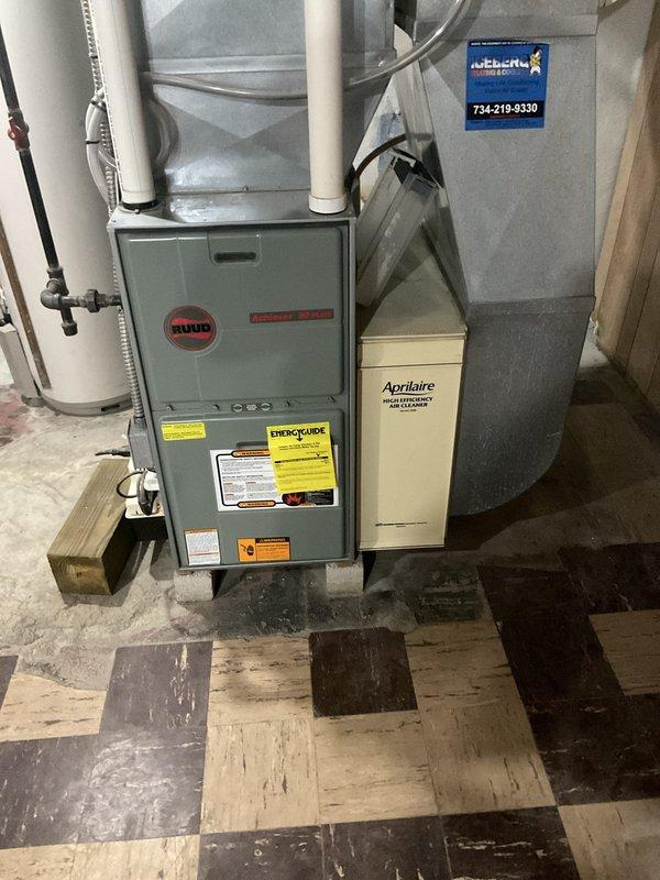Conducted on-site assessment of existing residential HVAC system consisting of gray Ruud furnace with Aprilaire whole home air cleaning system in basement installation. Documented current equipment configuration including PVC venting, ductwork plenum, and accessory components to provide comprehensive replacement estimate for customer consideration.