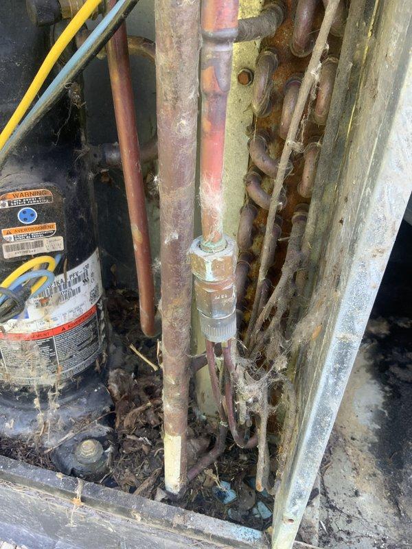 Responded to no cooling call for 30+ year old residential air conditioning system. Upon arrival, confirmed outdoor condensing unit fan motor not operating, resulting in complete loss of cooling to home. Performed diagnostic evaluation of outdoor unit and documented extensive age-related deterioration including heavily corroded refrigerant lines, deteriorated compressor components, and significant debris accumulation throughout system. Provided customer with comprehensive assessment confirming system has exceeded normal service life expectancy and recommended full system replacement due to age, condition, and unavailability of cost-effective repair options for equipment of this vintage.
