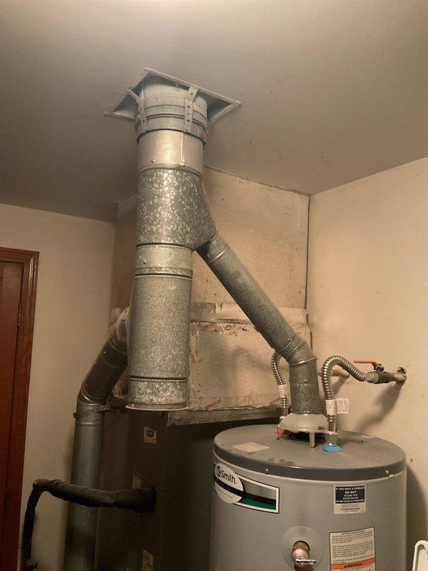 Conducted on-site evaluation for HVAC system replacement estimate in residential utility room. Documented existing equipment including gray metal furnace unit with galvanized ductwork system and A.O. Smith water heater with venting assembly. Recorded manufacturer model numbers and specifications from both furnace and air conditioning units for replacement quotation purposes. Photographed current installation configuration, including ductwork connections, piping arrangements, and equipment placement to ensure accurate system sizing and proper replacement planning.