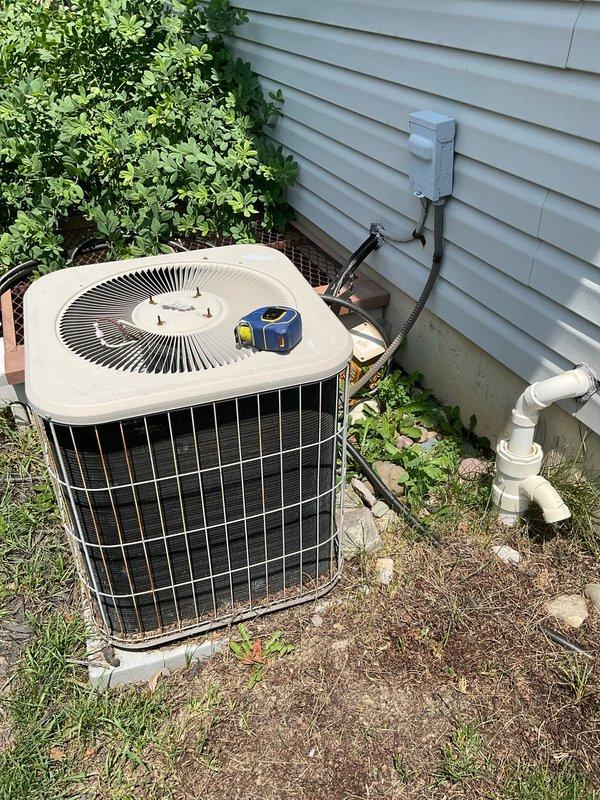 Conducted site assessment for replacement of 21-year-old HVAC system in 1400 square foot single family home. Evaluated existing Lennox furnace and outdoor condenser unit, both currently operational but nearing end of service life. Documented equipment specifications, ductwork configuration, and installation conditions in basement mechanical room and exterior location. Photographed current system setup including furnace with metallic ductwork, plenum assembly, and outdoor condenser unit with protective wire guard and electrical disconnect. Reviewed customer requirements for high-efficiency replacement system including 96% AFUE furnace with integrated humidifier. Prepared comprehensive estimate for Trane equipment installation as requested, accounting for existing infrastructure, clearances, ventilation requirements, and electrical connections to support proactive system upgrade.