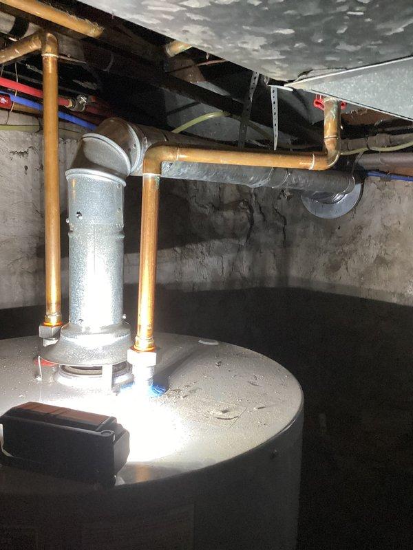 Responded to service call to verify furnace venting configuration prior to planned chimney removal during roof work. Conducted thorough inspection of basement mechanical systems and documented all venting arrangements. Confirmed that the furnace utilizes PVC direct vent system independent of the masonry chimney, while the atmospheric water heater currently vents through the existing chimney flue. Photographed all relevant mechanical equipment, ductwork routing, and venting connections to provide clear documentation for the roofing contractor and homeowner. Advised that the gas-fired water heater will require alternative venting solution or replacement with direct-vent or power-vent unit before chimney can be safely removed, as current atmospheric draft configuration is dependent on the chimney stack.