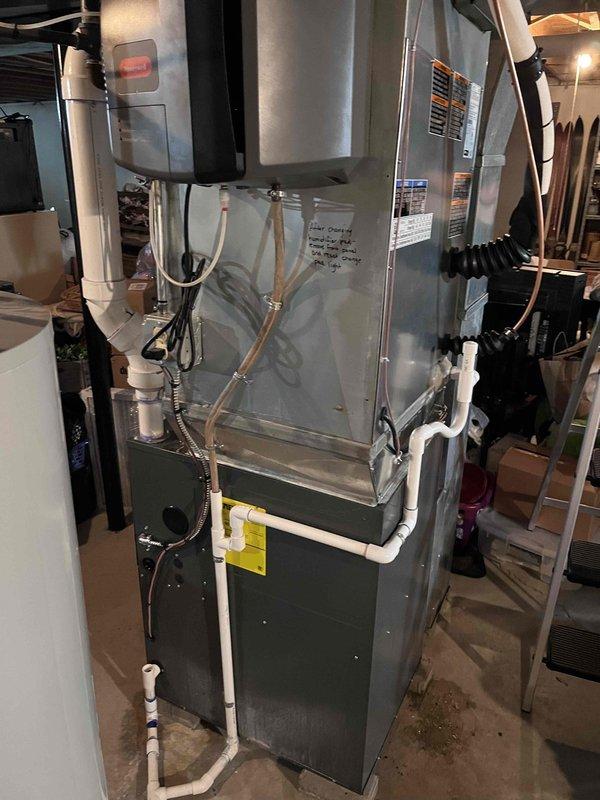 Completed installation of 3.5-ton air conditioning system with evaporator coil, including mechanical and electrical connections to existing furnace unit. System was evacuated to proper vacuum levels (26.7 microns verified with digital gauge), refrigerant lines were connected and secured, and electrical disconnect was wired per code requirements.