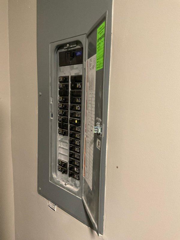 Conducted on-site evaluation of existing HVAC system for equipment replacement estimate. Assessed current natural gas furnace and non-operational air conditioning unit located in indoor mechanical room, documented electrical panel configuration with approximately 20-24 circuit breakers, and photographed existing equipment installation including gas line connections, ductwork configuration, and floor-mounted unit positioning to determine replacement specifications and system requirements.