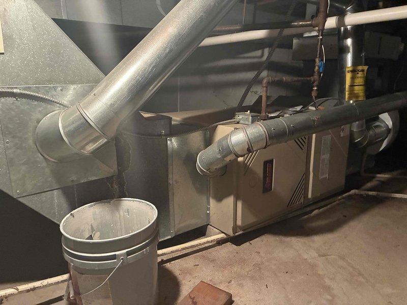 Conducted estimate for residential HVAC system experiencing refrigerant loss and freeze-up conditions. System operating on R22 refrigerant was determined to be beyond economical repair due to age and extent of required work. Documented existing basement installation including furnace, ductwork configuration, and connected water heater for replacement specifications. Provided comprehensive assessment and recommended full system replacement as most cost-effective solution.