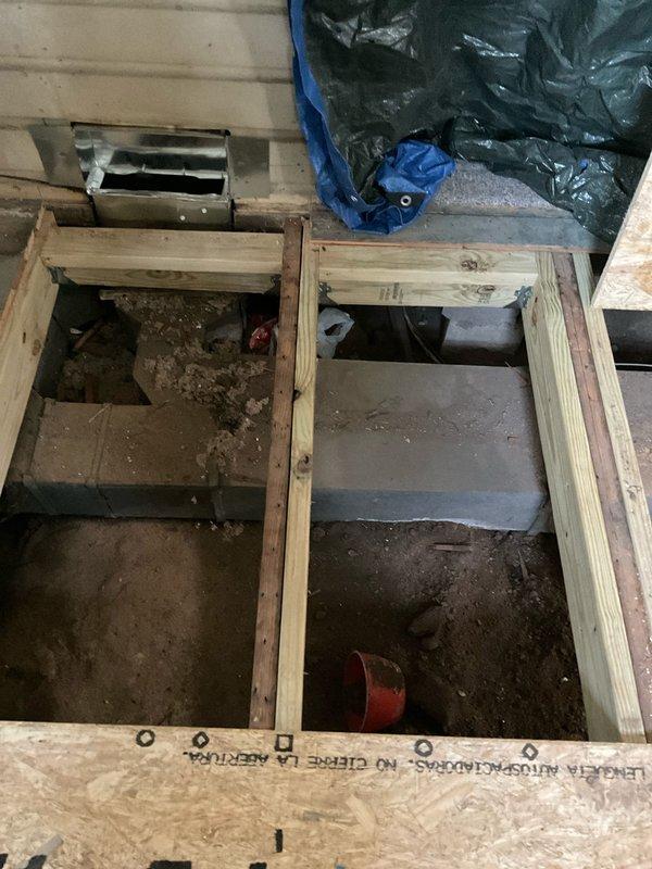 Provided estimate for replacement of leaking furnace ductwork located beneath kitchen floor. Assessed exposed subfloor area with removed flooring, revealing damaged ductwork system within floor cavity requiring full replacement due to air leakage compromising system efficiency.