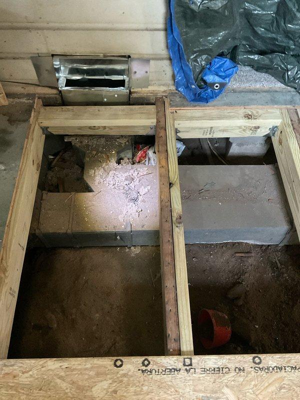 Provided estimate for replacement of leaking furnace ductwork located beneath kitchen floor. Assessed exposed subfloor area with removed flooring, revealing damaged ductwork system within floor cavity requiring full replacement due to air leakage compromising system efficiency.