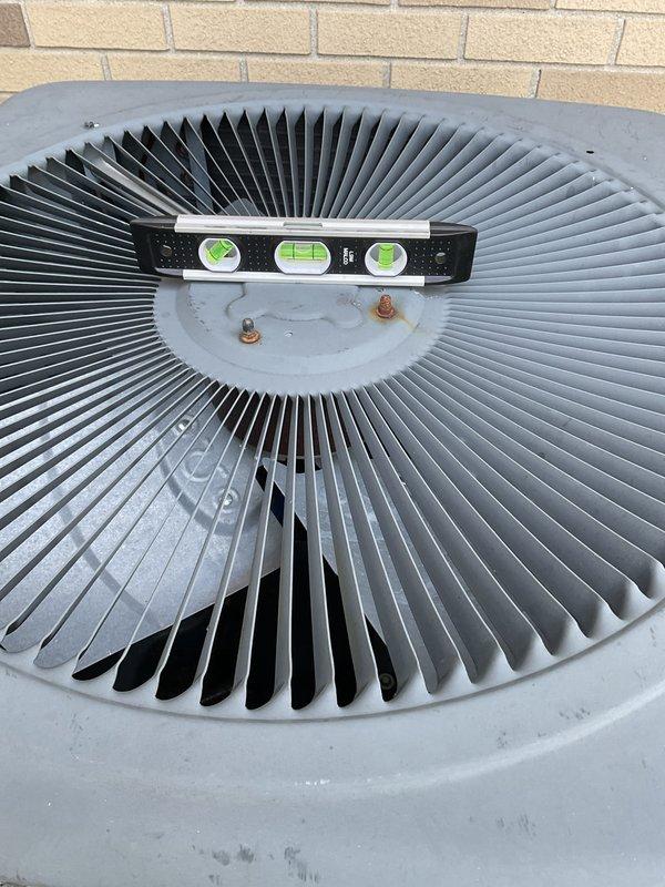 Completed preventive maintenance inspection on outdoor condensing unit as part of Club AC8-12 agreement. Verified unit levelness using torpedo level, inspected fan assembly and blades for proper operation and condition, and confirmed clean exterior components with no visible damage or debris. Inspected electrical panel and capacitor (40/5 MFD rating), verified all wire connections secure at terminals, checked capacitor mounting and condition, and confirmed all electrical components functioning within normal parameters.