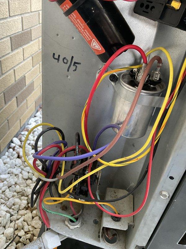 Completed preventive maintenance inspection on outdoor condensing unit as part of Club AC8-12 agreement. Verified unit levelness using torpedo level, inspected fan assembly and blades for proper operation and condition, and confirmed clean exterior components with no visible damage or debris. Inspected electrical panel and capacitor (40/5 MFD rating), verified all wire connections secure at terminals, checked capacitor mounting and condition, and confirmed all electrical components functioning within normal parameters.