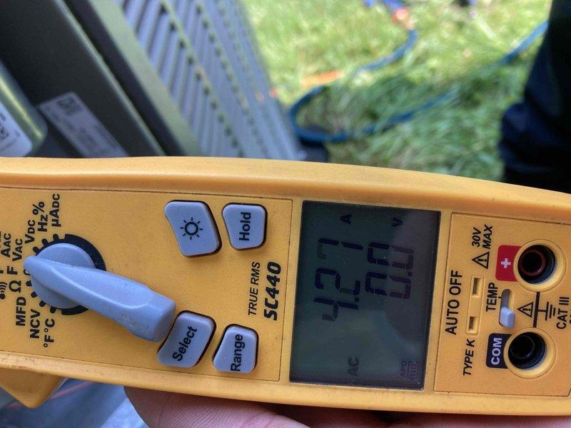 Responded to scheduled AC maintenance agreement visit. Attempted customer contact prior to arrival with no answer. Performed system diagnostics and electrical measurements using digital multimeter, recording voltage readings of 43.3V and 250V AC to verify proper electrical supply and component operation. Documented equipment conditions with photos for service records.