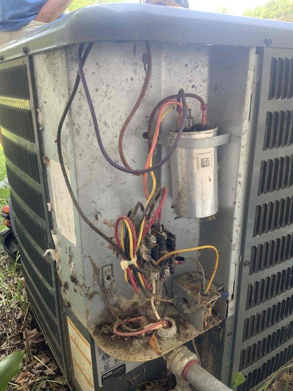 Responded to no-cooling complaint on 20-year-old central air conditioning system. Upon arrival, confirmed no cool air from registers with supply air at ambient temperature. Accessed outdoor condensing unit and performed visual inspection of electrical components. Found failed dual-run capacitor preventing compressor and condenser fan motor operation. Removed defective capacitor and installed replacement capacitor with proper MFD ratings per manufacturer specifications. Verified all electrical connections secure and properly terminated. Cleared debris accumulation from unit base and interior compartment. Cycled system through complete cooling operation. Confirmed compressor engagement, condenser fan motor operation, and proper amp draw on both components. Verified temperature split at supply registers within acceptable range. System restored to normal cooling operation.