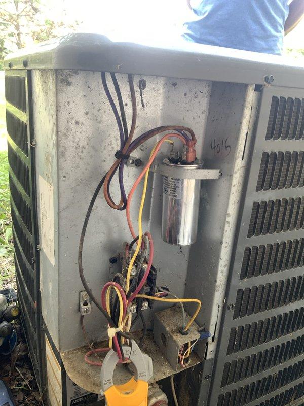 Responded to no-cooling complaint on 20-year-old central air conditioning system. Upon arrival, confirmed no cool air from registers with supply air at ambient temperature. Accessed outdoor condensing unit and performed visual inspection of electrical components. Found failed dual-run capacitor preventing compressor and condenser fan motor operation. Removed defective capacitor and installed replacement capacitor with proper MFD ratings per manufacturer specifications. Verified all electrical connections secure and properly terminated. Cleared debris accumulation from unit base and interior compartment. Cycled system through complete cooling operation. Confirmed compressor engagement, condenser fan motor operation, and proper amp draw on both components. Verified temperature split at supply registers within acceptable range. System restored to normal cooling operation.