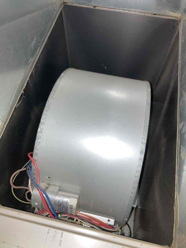 Responded to no cooling complaint at condo unit 2B. Upon inspection, found blower motor assembly and wheel heavily coated with accumulated dust, dirt, and debris, severely restricting airflow throughout the system. The excessive buildup on the blower wheel was preventing proper air circulation, resulting in inadequate cooling to the entire apartment. Documented conditions with photographs showing the extent of contamination on the blower motor, capacitor connections, and surrounding components. Customer was informed of findings and provided with recommendations for system cleaning and maintenance to restore proper operation.