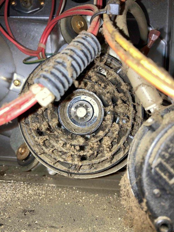 Responded to no cooling complaint at condo unit 2B. Upon inspection, found blower motor assembly and wheel heavily coated with accumulated dust, dirt, and debris, severely restricting airflow throughout the system. The excessive buildup on the blower wheel was preventing proper air circulation, resulting in inadequate cooling to the entire apartment. Documented conditions with photographs showing the extent of contamination on the blower motor, capacitor connections, and surrounding components. Customer was informed of findings and provided with recommendations for system cleaning and maintenance to restore proper operation.