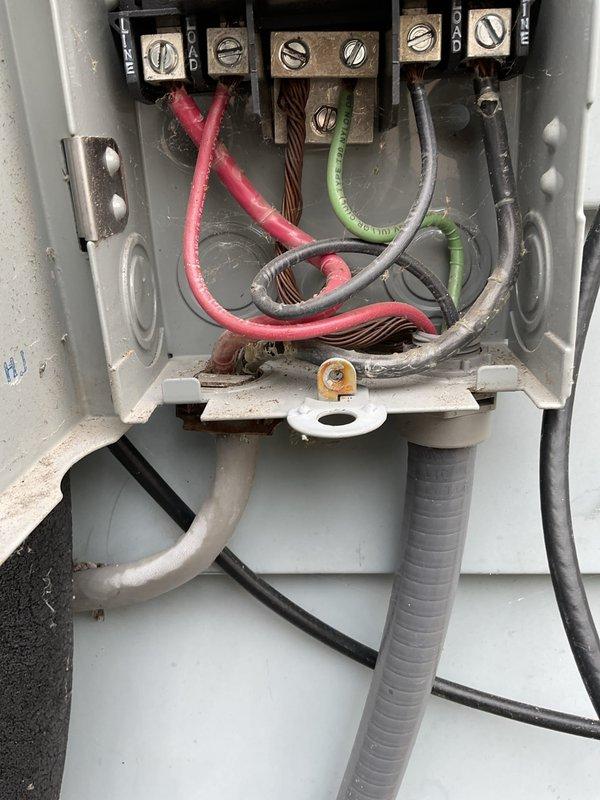 Responded to no cooling complaint on aging air conditioning system. Upon arrival, found unit operating continuously per customer request despite warm air discharge. Performed system inspection including electrical disconnect examination and condenser unit assessment. Verified unit levelness and documented electrical connections at service disconnect showing multiple wire terminations and proper grounding configuration. Inspected outdoor condenser unit with fan assembly operational, though system failing to provide adequate cooling. Customer declined to power down system during diagnostic evaluation, limiting troubleshooting capabilities for refrigerant charge verification and compressor amperage testing under proper conditions.