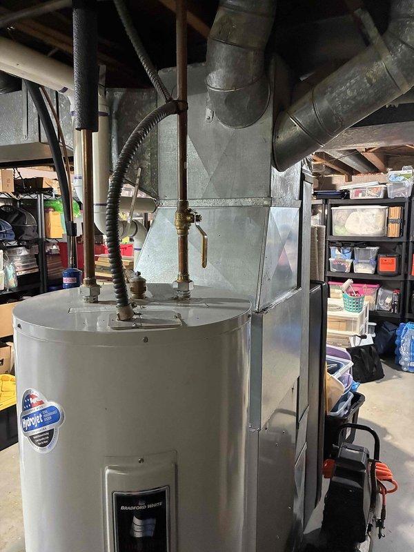Completed comprehensive assessment of 15-year-old residential air conditioning system experiencing multiple component failures. Diagnosed failed contactor and capacitor, along with severe refrigerant undercharge condition. Documented existing Bryant HVAC system installation in basement utility area, including furnace unit and associated ductwork configuration. Provided detailed replacement estimate for aging AC system given the extent of repairs needed and age of equipment.