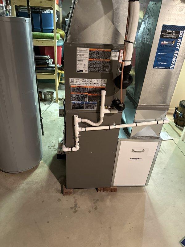 Completed full HVAC system installation in basement utility area including new furnace, air conditioning system with outdoor condenser unit located in rear yard, humidifier integration, and all necessary mechanical and electrical connections. Installed condensate pump with PVC drainage system, established proper ductwork connections, completed electrical wiring and reconnections per code requirements, and verified all system components are operational and functioning correctly.
