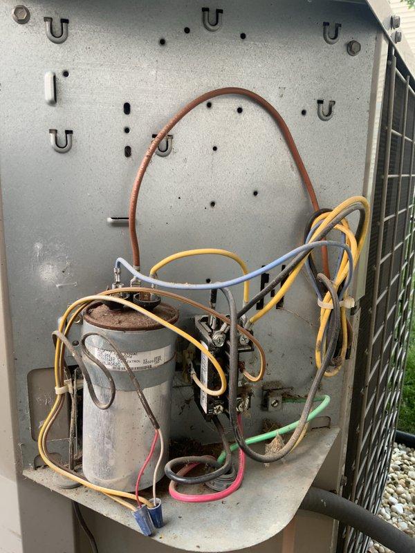 Responded to no-cool call on 20-year-old central air conditioning system with non-operational condenser fan. Upon inspection, diagnosed failed dual run capacitor preventing compressor and fan motor operation. Replaced defective capacitor with OEM-equivalent component rated to manufacturer specifications. Verified proper voltage supply, tested both compressor and condenser fan motor startup, confirmed adequate amperage draw on both circuits, and restored system to normal cooling operation.