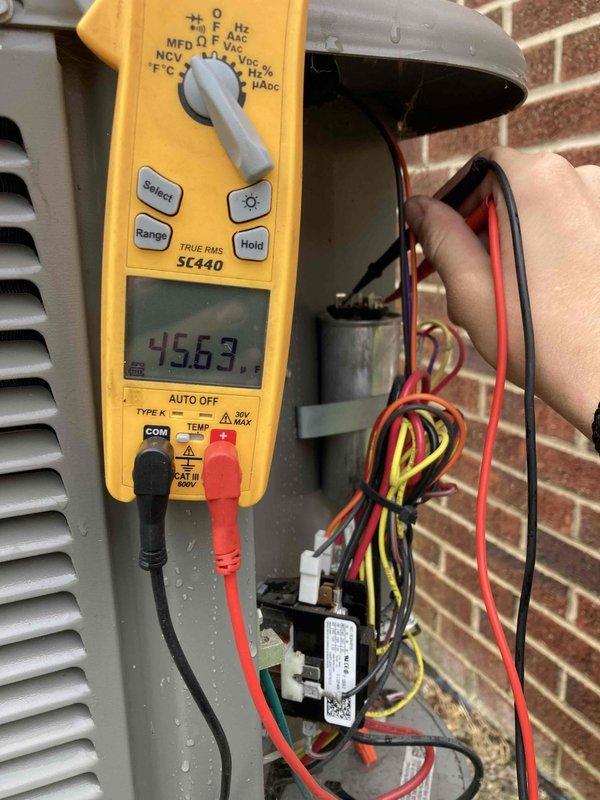Completed preventive maintenance agreement visit on air conditioning system. Performed electrical diagnostics using digital multimeter to verify proper voltage and amperage readings at control panel, inspected condenser motor assembly and blower wheel for proper operation and condition, and documented system components with photographic records per maintenance protocol.