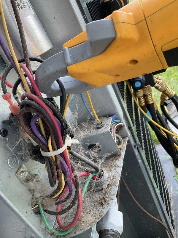 Responded to no cooling complaint on residential air conditioning system. Performed visual inspection of outdoor condensing unit, noting accumulated dirt, debris, and spider webs around electrical connections and components. Electrical disconnect switch and wiring connections were inspected and found intact. Refrigerant line connections with service ports were visually verified. Unit showed signs of deferred maintenance with heavy soiling on exterior components and electrical junction areas, which can impact system efficiency and cooling performance.