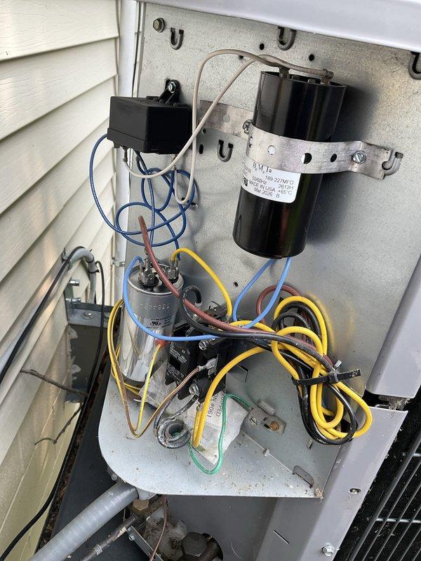 Responded to no cooling complaint on residential air conditioning system approximately 2-3 years old. Upon arrival, verified thermostat set to 72°F with indoor temperature reading 83°F and rising. Performed diagnostic evaluation of outdoor condensing unit, accessing electrical control panel to inspect compressor, capacitors, contactors, and associated wiring. Utilized clamp meter to measure electrical parameters including voltage, amperage, and capacitance values at disconnect box and control board. Identified system malfunction preventing compressor operation. Documented equipment condition and electrical component configuration with photographs for service records. System requires repair to restore cooling functionality.