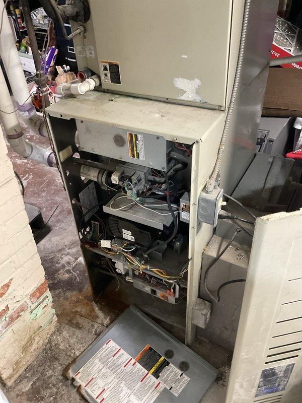 Provided comprehensive estimate for natural gas furnace replacement in basement utility area. Existing Carrier unit was condemned by DTE and is non-operational, requiring complete system replacement. Evaluated current installation including ductwork configuration, venting system with PVC condensate drain, electrical service panel connections, and thermostat controls to determine proper replacement specifications and scope of work.