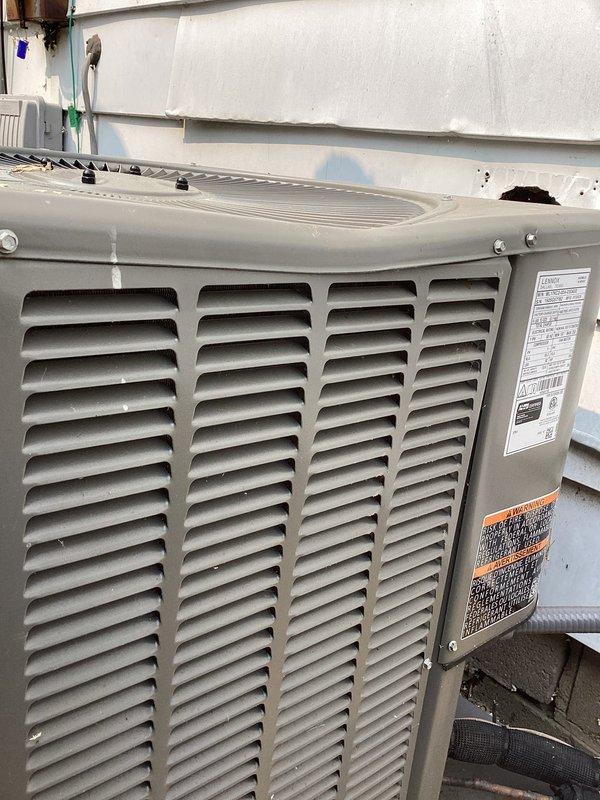 # Service Completed

Responded to emergency service call for physical damage to outdoor condensing unit caused by tree removal company. Unit is a recent installation from our company. Performed comprehensive damage assessment and photographic documentation of all affected components for insurance claim purposes.

Upon arrival, conducted thorough visual inspection of condensing unit exterior and interior components. Documented extensive impact damage to top grille assembly, cabinet panels, and internal components. Photographed damaged ventilation louvers, displaced foam insulation strips, and compromised cabinet structure. Inspected refrigerant lines, electrical connections, and compressor housing for secondary damage from impact.

Verified unit model and serial numbers from manufacturer labels for claim documentation. Assessed structural integrity of mounting pad and confirmed unit remains level and properly positioned. Checked for refrigerant leaks at all connection points and service