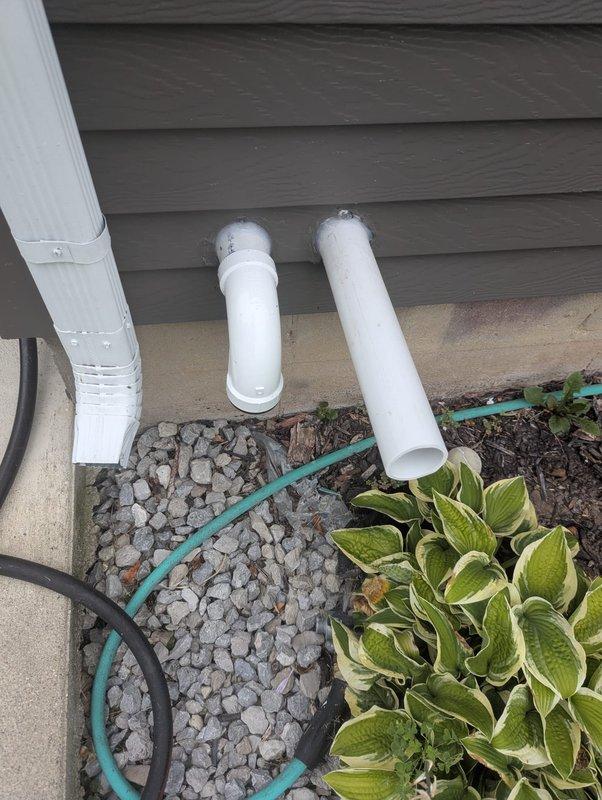 Completed full HVAC system installation including a 90,000 BTU Lennox furnace and 3-ton air conditioning unit positioned in the left side yard. The mechanical equipment was installed in the basement utility area with proper ductwork configuration, while the outdoor condenser unit was set on the side yard with appropriate PVC condensate drainage lines routed through the foundation landscaping. All components were connected, tested, and verified operational upon completion.