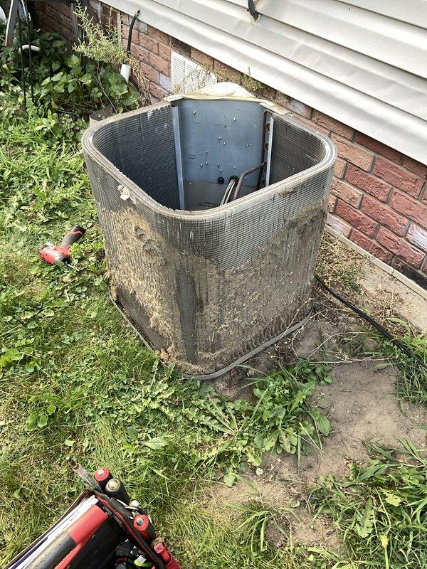 # HVAC Service Report - No Cooling Emergency

Responded to emergency service call for central air conditioning system producing loud hissing noise for approximately fifteen minutes before being shut down by occupant. Upon arrival, performed visual inspection of outdoor condensing unit, which exhibited significant weathering, dirt accumulation, and lack of recent maintenance. Unit showed heavy buildup of debris, grime, and environmental staining on exterior coil fins and surfaces.

Conducted system diagnostic to identify source of hissing noise and determine operational status. Inspected refrigerant lines, connections, and condenser coil for potential leaks or damage. Evaluated compressor, fan motor, and electrical components for proper function. Checked refrigerant pressures and system charge levels.

Identified active refrigerant leak as source of hissing noise. Located leak point and assessed severity of refrigerant loss. Due to extent of contamination on condenser coil and overall u