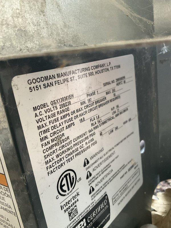 Responded to emergency no-heat call for a 5-year-old Goodman GSX130361EH system that was circulating air but not providing heat. Upon arrival, inspected outdoor condenser unit which showed significant dirt and debris accumulation on exterior surfaces and top grille, indicating lack of routine maintenance. Verified unit model and specifications from manufacturer nameplate, confirmed 208/230V power supply at disconnect box, and documented equipment condition. System blower operation confirmed but heating function not operational, requiring further diagnostic evaluation of heat source components.