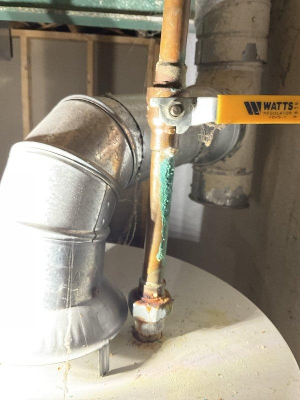 Responded to emergency no-heat call for a ten-year-old hot water boiler that had burst, leaving the property without heat or domestic hot water. Upon arrival, found the water supply had already been shut off to prevent further damage. Documented the failed boiler components, including severely corroded copper piping with visible verdigris staining and deteriorated galvanized fittings at connection points. Photographed the extent of corrosion at pipe joints and the compromised plumbing assembly for insurance and replacement documentation purposes.