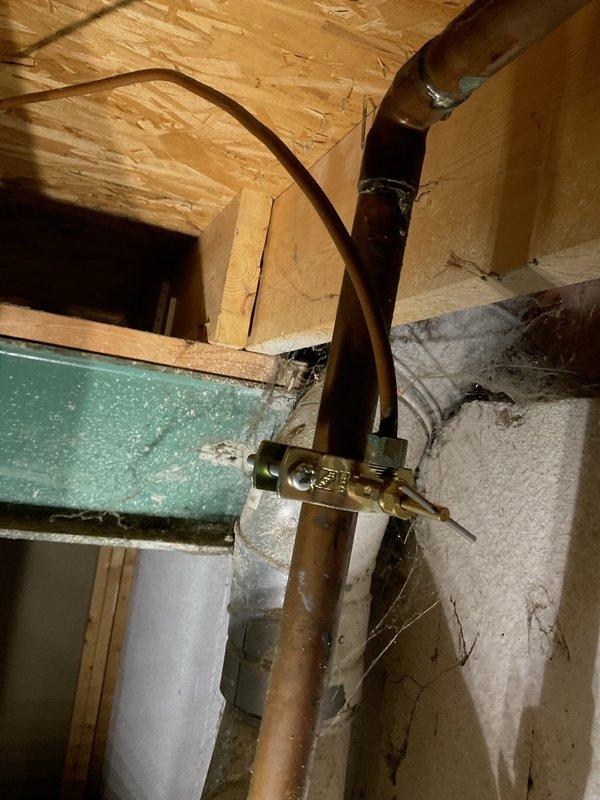 Responded to emergency no-heat call for a ten-year-old hot water boiler that had burst, leaving the property without heat or domestic hot water. Upon arrival, found the water supply had already been shut off to prevent further damage. Documented the failed boiler components, including severely corroded copper piping with visible verdigris staining and deteriorated galvanized fittings at connection points. Photographed the extent of corrosion at pipe joints and the compromised plumbing assembly for insurance and replacement documentation purposes.