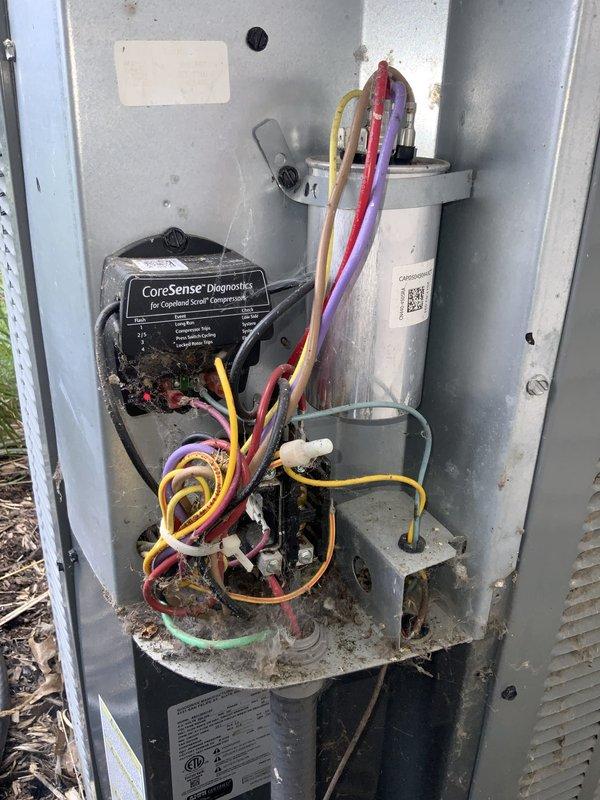 Responded to emergency service call for intermittent cooling loss affecting entire residence with 10-year-old Amana AC system. Upon arrival, accessed outdoor condensing unit and performed diagnostic evaluation of electrical and control components. Inspected control board, capacitor, and wiring connections throughout the unit. Found CoreSense Diagnostics module installed for compression monitoring. Noted accumulation of outdoor debris and dirt within electrical compartment that could contribute to intermittent operation. Examined all wire terminals and connections for signs of overheating, corrosion, or loose contacts. Evaluated Emerson control board and associated circuitry for proper operation. Checked condensate drainage system which showed water staining indicating normal operation. All electrical connections secured and system components verified for proper function. Documented equipment condition with photographs showing internal wiring configuration and component layout. System o