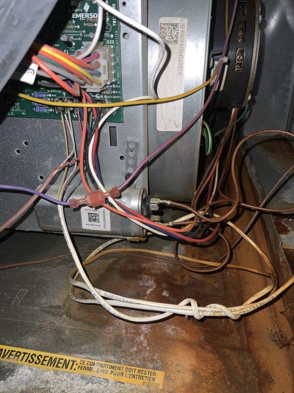 Responded to emergency service call for intermittent cooling loss affecting entire residence with 10-year-old Amana AC system. Upon arrival, accessed outdoor condensing unit and performed diagnostic evaluation of electrical and control components. Inspected control board, capacitor, and wiring connections throughout the unit. Found CoreSense Diagnostics module installed for compression monitoring. Noted accumulation of outdoor debris and dirt within electrical compartment that could contribute to intermittent operation. Examined all wire terminals and connections for signs of overheating, corrosion, or loose contacts. Evaluated Emerson control board and associated circuitry for proper operation. Checked condensate drainage system which showed water staining indicating normal operation. All electrical connections secured and system components verified for proper function. Documented equipment condition with photographs showing internal wiring configuration and component layout. System o