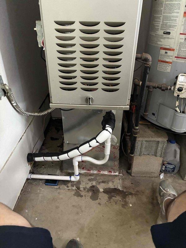 Completed installation of a 2-ton air conditioning system with mechanical equipment positioned at rear of property. Successfully reconnected all electrical components, installed new air filtration system with wall-mounted bracket, and configured PVC condensate drainage piping with proper insulation at connection points. All financing documentation processed and identification verification completed for Michigan Saves program approval.