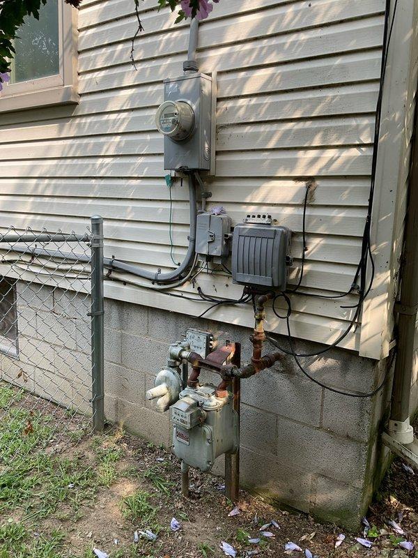 Conducted comprehensive site evaluation for new whole home generator installation at residential property. Assessed existing electrical service panel, utility meter configuration, and natural gas supply infrastructure to determine optimal placement and connection requirements. Documented current electrical and gas meter locations, evaluated available clearances from structure and property boundaries, and identified necessary upgrades to support automatic transfer switch integration with main electrical panel for seamless backup power operation.