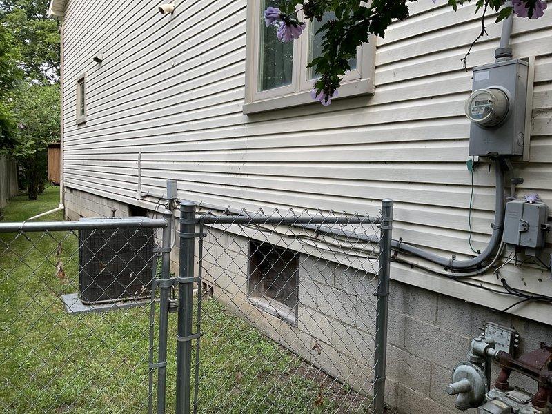 Conducted comprehensive site evaluation for new whole home generator installation at residential property. Assessed existing electrical service panel, utility meter configuration, and natural gas supply infrastructure to determine optimal placement and connection requirements. Documented current electrical and gas meter locations, evaluated available clearances from structure and property boundaries, and identified necessary upgrades to support automatic transfer switch integration with main electrical panel for seamless backup power operation.