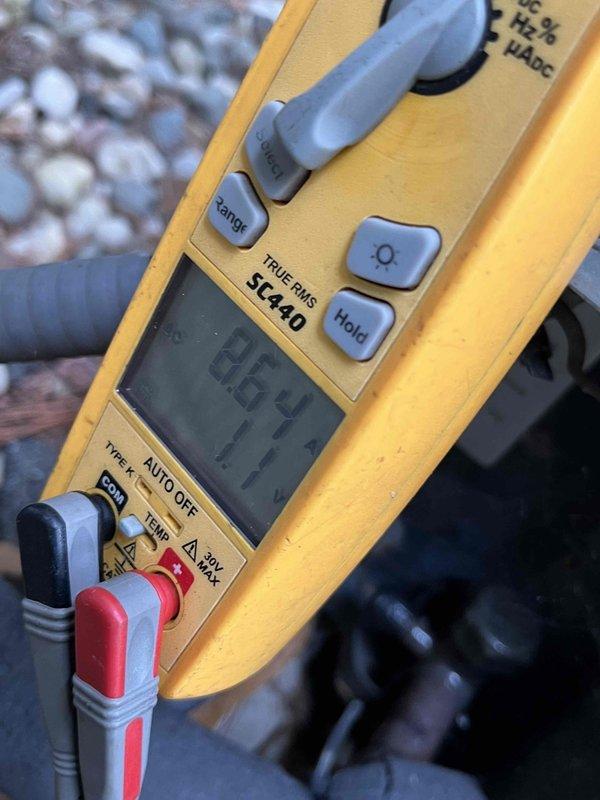 Completed AC Club preventive maintenance agreement visit on residential heat pump system. Performed comprehensive system diagnostics using digital multimeter, recording voltage readings of 92.4V and 447V at key electrical test points to verify proper power supply and compressor operation. Inspected outdoor condenser unit including fan motor assembly and condenser coil fins, confirming all components operating within normal parameters.