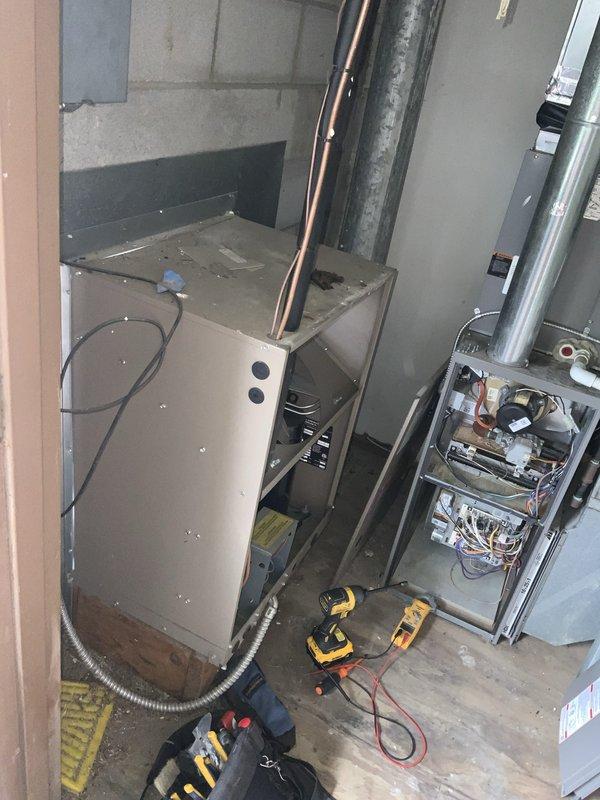 Responded to no cooling call on 15-year-old residential AC system. Upon arrival, performed diagnostic evaluation of unit including electrical system inspection and component testing. Accessed interior panels to examine wiring connections, control boards, and relay components. Utilized multimeter and diagnostic tools to test electrical continuity and identify failure points. Documented system condition with photos showing internal wiring configuration and overall equipment status. Completed thorough assessment of aging HVAC equipment to determine cause of complete system failure and provided findings to customer for repair recommendations.
