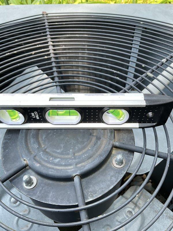 Completed routine maintenance inspection on outdoor AC condensing unit. Verified unit levelness using precision level tool and inspected electrical components including capacitor and associated wiring connections. All components found to be properly secured and functioning within normal parameters.