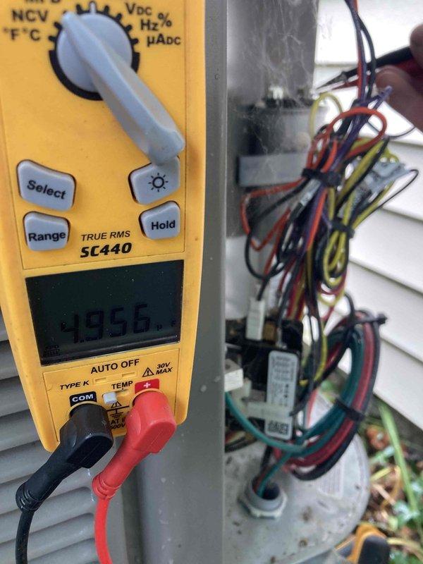 Completed preventive maintenance inspection under Club AC12-4 agreement. Performed comprehensive system evaluation including evaporator coil inspection, which showed clean fins in good condition with no debris accumulation or corrosion. Conducted electrical diagnostics using digital multimeter, recording voltage reading of 495.6V at the unit's electrical connections. Verified all wiring connections at the outdoor unit, inspecting multiple circuit connections including power and control wiring. All system components operating within normal parameters with no deficiencies noted at time of inspection.