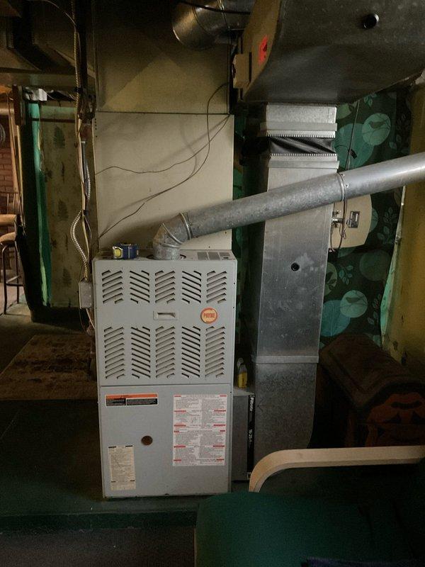 Completed comprehensive HVAC system assessment for replacement estimate of existing furnace and air conditioning equipment located in basement mechanical room. Evaluated current installation including furnace unit with existing ductwork configuration, plenum connections, and upflow air handler system to provide accurate replacement specifications and equipment sizing recommendations for 4-6 ton capacity system upgrade.