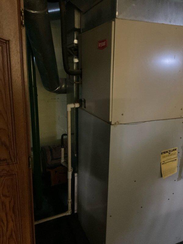 Completed comprehensive HVAC system assessment for replacement estimate of existing furnace and air conditioning equipment located in basement mechanical room. Evaluated current installation including furnace unit with existing ductwork configuration, plenum connections, and upflow air handler system to provide accurate replacement specifications and equipment sizing recommendations for 4-6 ton capacity system upgrade.