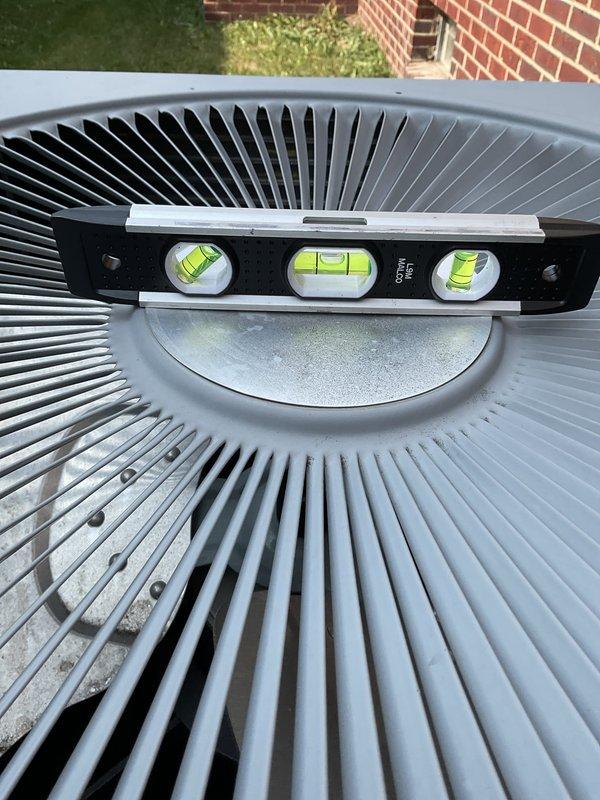 # HVAC Service Report

Responded to no cooling complaint with unit intermittently tripping and shutting down. Upon arrival, found outdoor condenser unit significantly unlevel, which can cause compressor oil migration issues and premature component failure. Used precision level to verify unit was out of specification on mounting pad. Checked unit levelness in multiple directions to assess severity of installation issue. Unit's unlevel condition likely contributing to electrical safety trips and operational shutdowns. Documented current positioning for correction requirements. Recommended immediate releveling of condenser unit on pad to prevent compressor damage and restore proper system operation.