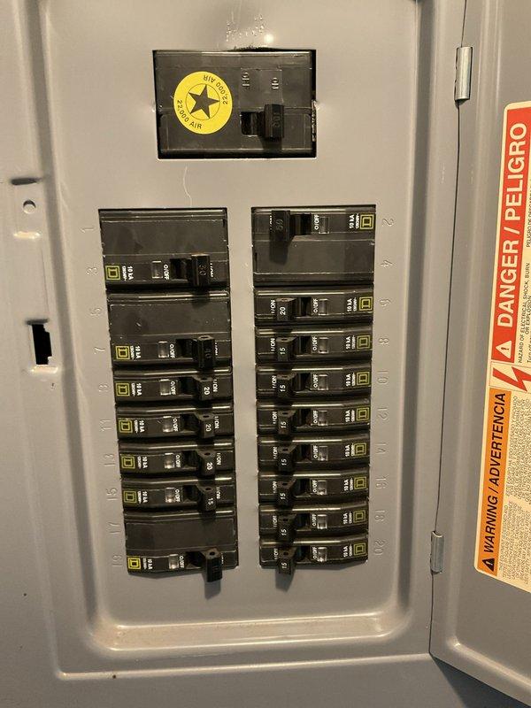 Conducted equipment evaluation for non-operational Bryant air conditioning condenser unit aged 8-10 years located at exterior brick wall installation. Assessed existing electrical service including circuit breaker panel configuration and outdoor disconnect box, documented equipment condition and surrounding landscape considerations including dense ground cover and climbing vegetation requiring clearance attention. Provided comprehensive replacement estimate for complete system upgrade.