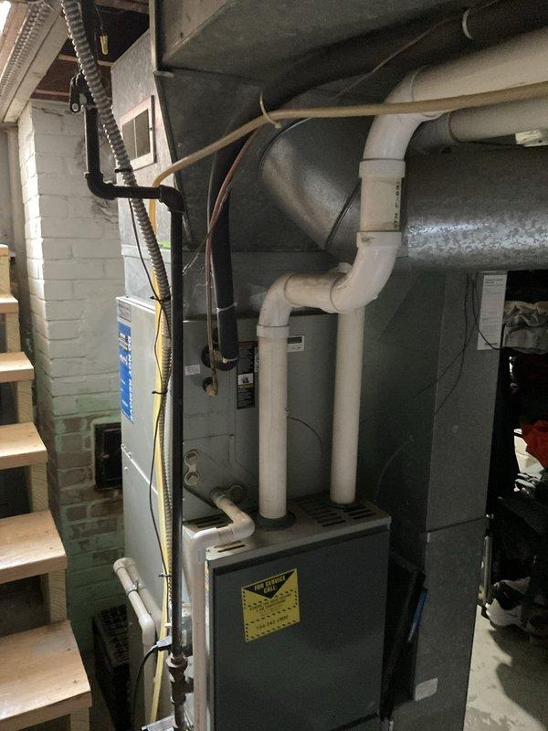 Conducted comprehensive on-site evaluation for full HVAC system replacement in residential property. Assessed existing furnace unit, ductwork configuration, and ventilation system located in basement mechanical room. Documented current equipment specifications, including furnace with associated metallic flexible ducting, gray metal plenum chamber, and PVC drainage/ventilation piping. Evaluated ductwork integrity and routing throughout structure, including attic space accessibility for potential air handler or ductwork modifications. Photographed all existing equipment and infrastructure to develop accurate replacement specifications and identify any necessary modifications to electrical, venting, or structural supports required for new system installation.