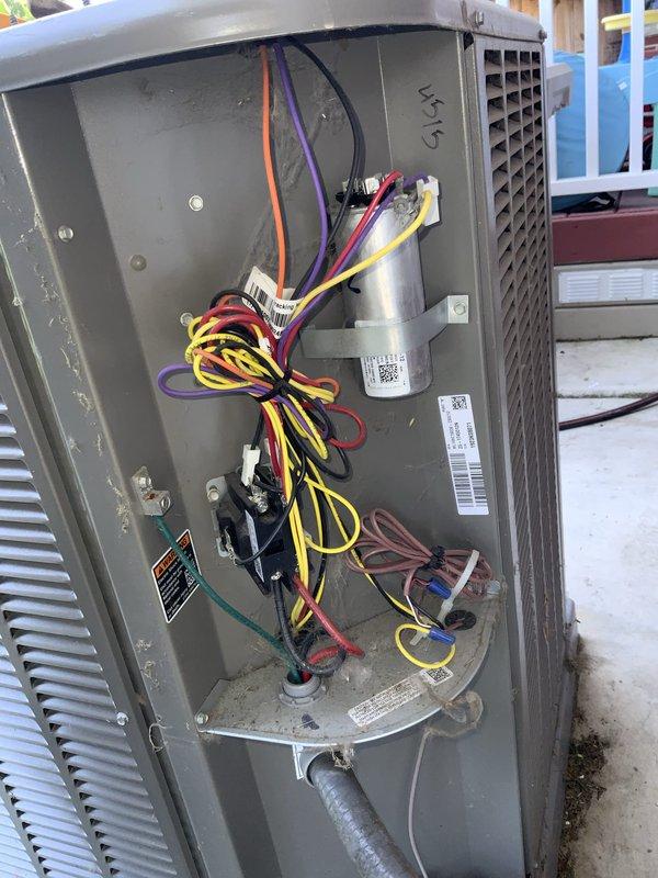 Responded to no cooling call on residential air conditioning system installed two years prior by another contractor. Upon arrival, accessed outdoor condensing unit and performed diagnostic evaluation of electrical components, controls, and capacitor. Inspected internal wiring connections, contactor operation, and capacitor condition to identify cause of complete cooling failure. Documented system condition with photos showing electrical compartment layout and component configuration for service records.