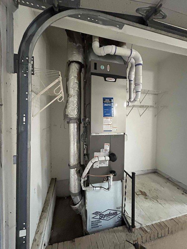 Completed full HVAC system installation including 110,000 BTU gas furnace, 4-ton air conditioning unit with rear discharge configuration, and whole-home humidifier in residential utility space. Installed new ductwork with insulated vertical supply plenum, white PVC condensate drainage lines, and proper venting system. Reconnected all electrical components to existing circuits and verified proper operation of heating and cooling systems. Positioned condensate overflow pan beneath furnace for safety compliance. All equipment properly mounted, secured, and labeled per manufacturer specifications and local building codes. System tested and confirmed operational with all components functioning as designed.