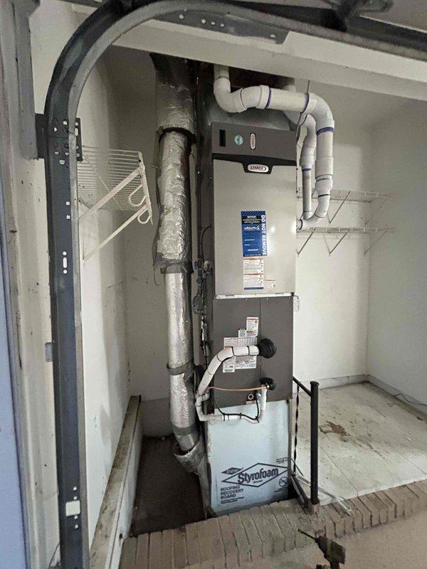 Completed full HVAC system installation including 110,000 BTU gas furnace, 4-ton air conditioning unit with rear discharge configuration, and whole-home humidifier in residential utility space. Installed new ductwork with insulated vertical supply plenum, white PVC condensate drainage lines, and proper venting system. Reconnected all electrical components to existing circuits and verified proper operation of heating and cooling systems. Positioned condensate overflow pan beneath furnace for safety compliance. All equipment properly mounted, secured, and labeled per manufacturer specifications and local building codes. System tested and confirmed operational with all components functioning as designed.
