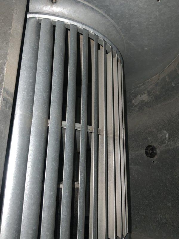 Completed preventative maintenance agreement visit for air conditioning system. Inspected and removed dirty air filter showing significant dust accumulation on pleated media, indicating proper filtration operation. Examined air handler components including curved metal plenum with vertical damper assembly, confirming proper structural condition and airflow control mechanisms functioning as designed.